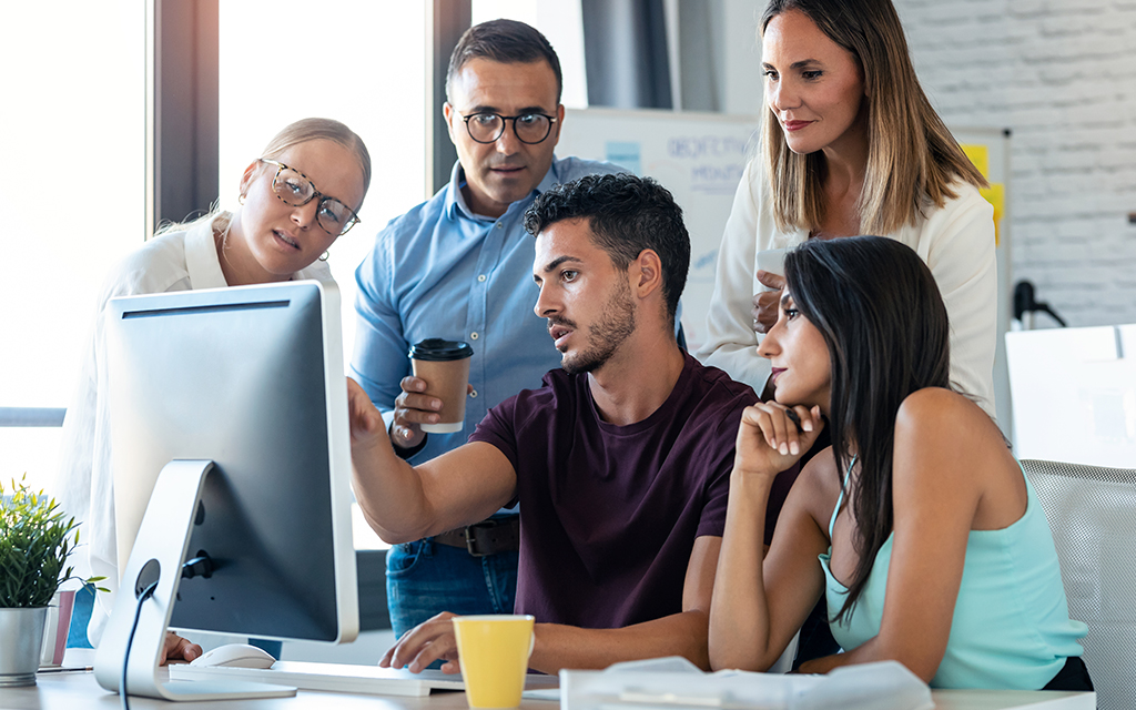 Young people start talking as a team while working in the corporate office.