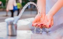 Drinking water coming out of a public fountain.